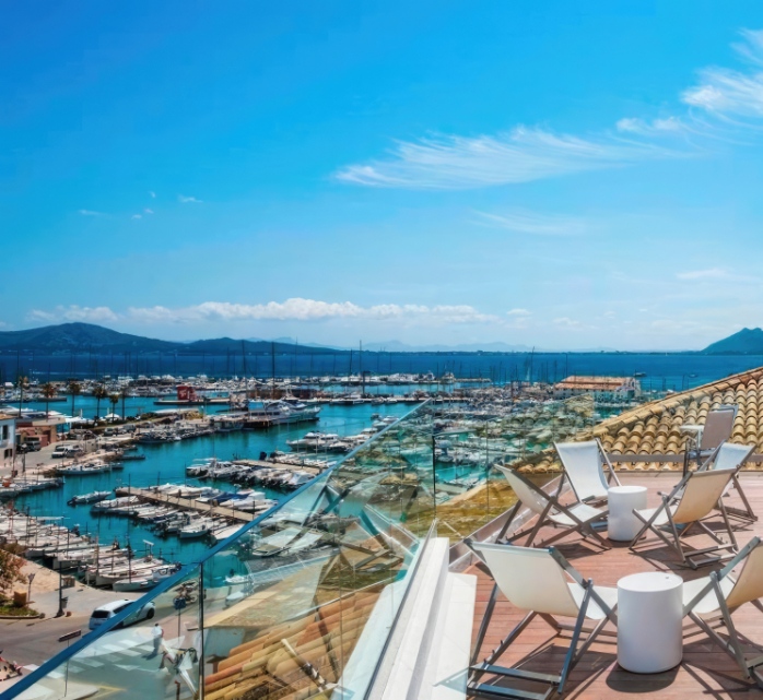 Fully equipped solarium terrace of the hotel with views of the Puerto Pollensa Yacht Club and the bay of Pollensa.